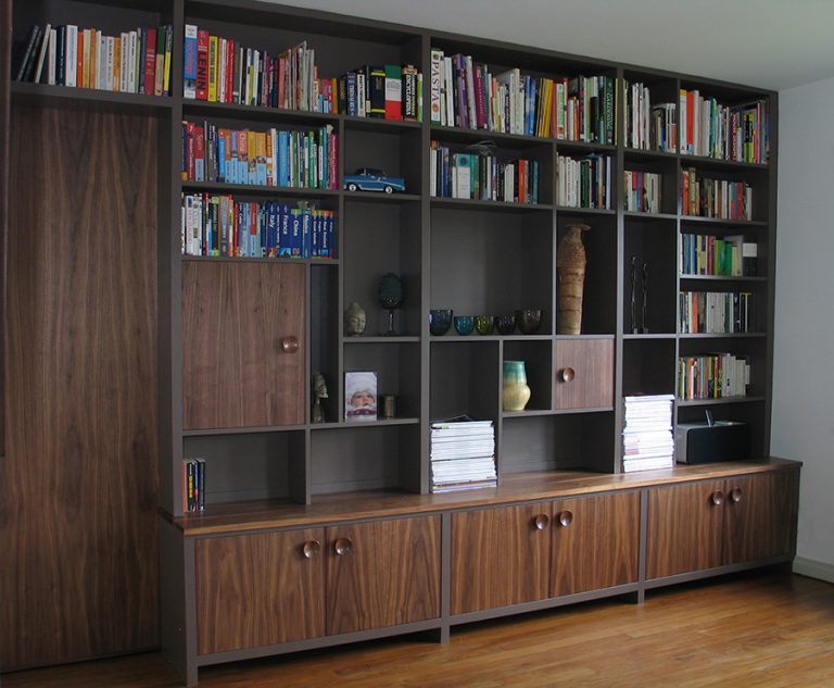 Fitted shelving and cupboard unit incorporating sliding door in American Black Walnut and painted finish